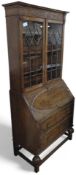 A 20th century oak bookcase bureau, with astragal