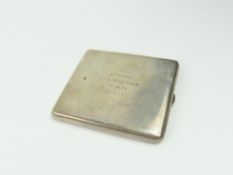 A silver cigarette case, of rectangular form, the cover engraved with a