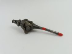 A coral and silver rattle with six bells and a whi