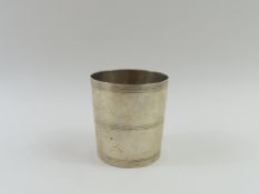 A silver beaker with three evenly spaced stiped de