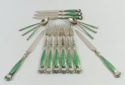 A set of silver fruit eaters and spoons