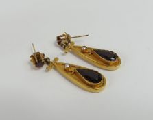 A pair of garnet and split pearl drop earrings