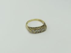 An 18ct gold diamond carved head ring, the five ro