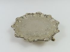 A silver card tray with intermittent shells at rim
