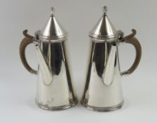 A pair of silver hot-chocolate pots, of smooth for