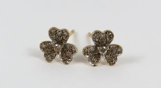 A pair of 9ct gold diamond set stud earrings in th