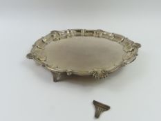 A circular silver salver with intermittent shell d