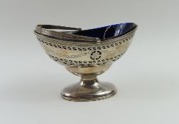 A silver salt dish with blue glass interior and sw