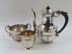 A silver coffee pot, milk jug and sugar bowl