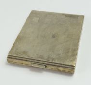 A silver cigarette case with Tartan pattern engrav