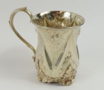 A Victorian silver cup with embossed floral features