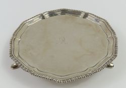A circular silver card tray with slightly pointed