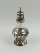 A silver sugar shaker with swirling-orb pattern ab
