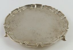 A plain silver salver with modest curved border. M