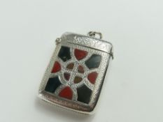 A silver vesta case, smooth on one face, and on th