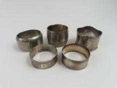 Four unique 20th-century silver napkin rings and o