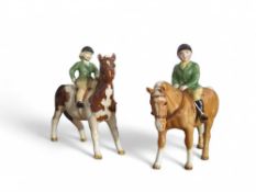 Two Beswick figures of children riding respective