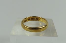 A plain 22ct gold wedding band, finger size P 1/2