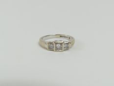 An 18ct white gold princess cut diamond three ston