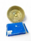A large and round brass wash basin with central pl