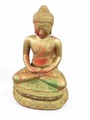 A metal Buddha statue painted gold but with some g
