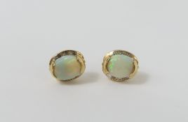 A pair of white opal and white stone stud earrings