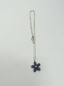 A sapphire and diamond set flower shaped pendant,