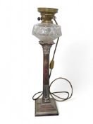 An Edwardian oil lamp, the moulded glass reservoir