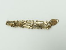 A 9ct gold three bar gate bracelet, two bars twist