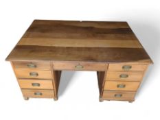 A 20th-century oak two-sided pedestal desk