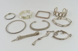 A silver flattened torque style bangle, a silver I