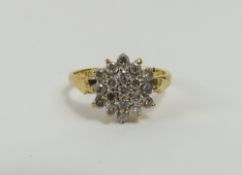 An 18ct gold diamond cluster ring, the round brill