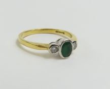 An 18ct gold emerald and diamond three stone ring,