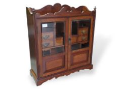 An early-20th-century oak smoker's cabinet