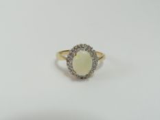 A 9ct gold white opal and diamond cluster ring, th