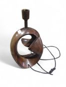 A contemporary artistic metal lamp, dark brown in
