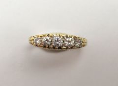 An 18ct gold diamond carved head ring, the five ro