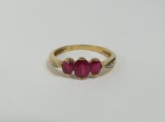 A ruby and diamond dress ring, the three oval rubi