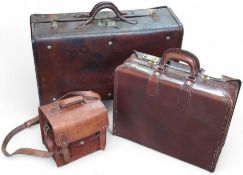 Two leather suitcases and a leather satchel