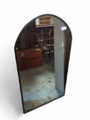 A tall modern overmantel mirror with felt rim lini