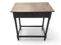 A reproduction stained-oak side drawer upon bobbin