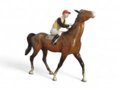 A Beswick figure of a pied jockey riding a trottin