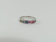 A multi coloured sapphire half eternity ring, the
