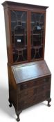A 20th-century mahogany bookcase-bureau