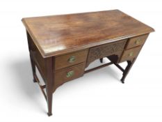 A mahogany desk with central drawer, between which
