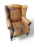 A modern leather wing-back armchair