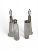 Four cut-glass scent bottles: two straight and the