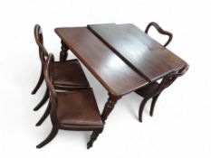 An Edwardian dining table with four chairs
