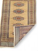 A patterned brown rug with some red and blue featu