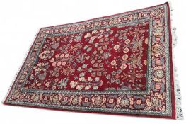 A red rug with white tassels